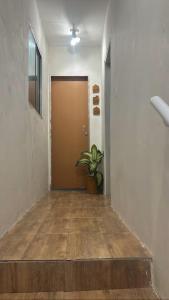 a hallway with a door and a potted plant at Loft Moderno in Mossoró