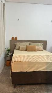 a large bed in a bedroom with a white wall at Loft Moderno in Mossoró