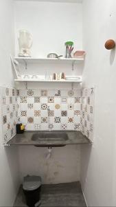a bathroom with a sink and shelves on a wall at Loft Moderno in Mossoró +7 photos