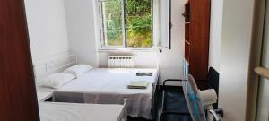 a small room with a bed and a window at Private Space near City Center in Genoa