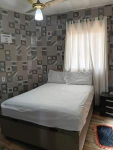 a bedroom with a bed with a curtain and a window at CHÁCARA DOMINGOS MARTINS - SANTO GRAAL - Montanhas, Corredeiras, Piscina, Natureza e Paz in Domingos Martins +38 photos