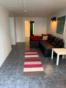 a living room with a couch and a table at Bageriet, 1 room, 2 beds in Varberg