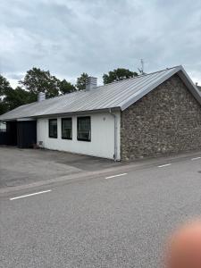 a brick and white building with a road in front of it at Bageriet, 1 room, 2 beds in Varberg