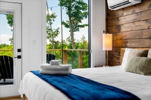 a bedroom with a bed and a large window at *Rooftop Deck*Hot Tub*Sauna*Fire Pit*Sunset Views* in Campton