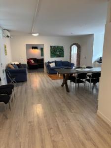 a living room with a table and a blue couch at Bageriet, 1 room, 2 beds in Varberg