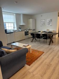 a living room with a table and a kitchen at Bageriet, 1 room, 2 beds in Varberg