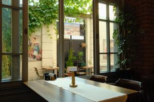 a room with a table and chairs and windows at madame roza in Istanbul