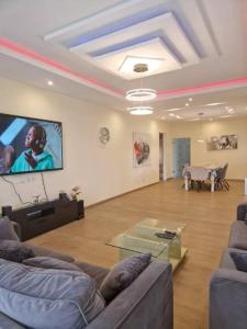 a living room with two couches and a tv at Appartement Güstrow "free energy from solar Panels" in Lomé