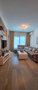 a living room with a couch and a table at Azure Horizon Pržno in Sveti Stefan