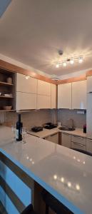 a kitchen with white cabinets and a white counter top at Azure Horizon Pržno in Sveti Stefan
