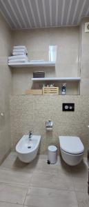 a bathroom with a sink and a toilet at Azure Horizon Pržno in Sveti Stefan