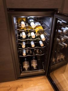 a refrigerator filled with lots of bottles of wine at Apartmán pod Pustým vrchem in Říčky +17 photos