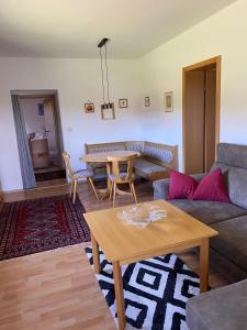 a living room with a couch and a table at Fe-Wo Berg und See in Hauzenberg
