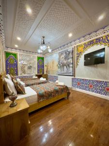 a bedroom with a bed in a room with colorful tiles at Meriton Hotel Bukhara in Bukhara
