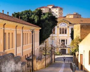 a person walking down a street in front of a building at Domo via Ozieri in Iglesias