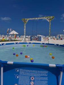 a pool table on the beach with balls on it at New Coast Chalets -K77 in Dawwār Muḩammad Abū Shunaynah