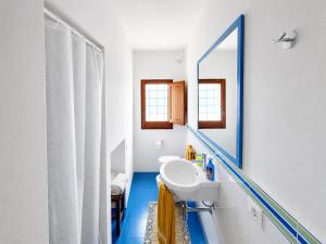 a bathroom with a sink and a mirror at Dammuso Ziloto - Cala Levante & Arco dell'Elefante in Pantelleria +27 photos