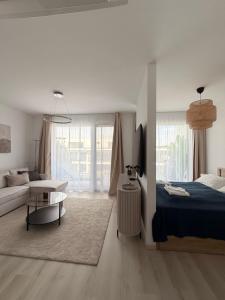 a bedroom with a bed and a living room at Waterfront studio in Balatonszemes +8 photos