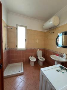 a bathroom with two toilets and a sink at Almar Apartments in Durrës +54 photos