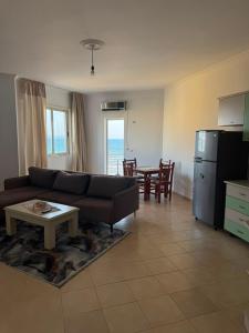 a living room with a couch and a table at Almar Apartments in Durrës