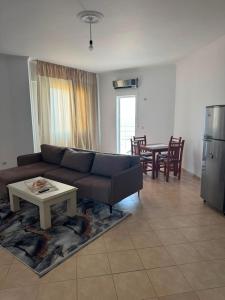 a living room with a couch and a table at Almar Apartments in Durrës