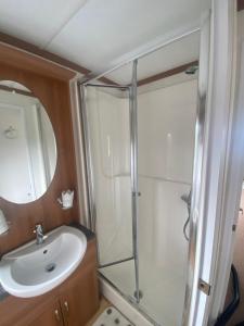 a bathroom with a shower and a sink at Angie Bs Beach Haven in Groomsport +17 photos