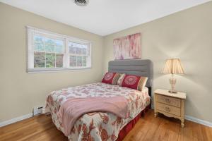 a bedroom with a bed and a lamp on a night stand at Muirs Chapel Retreat in Greensboro