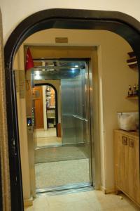 an archway leading into a hallway with a glass door at Roza Taksim in Istanbul