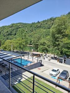 a view of a parking lot with a swimming pool at Apartment Zlatna plaža in Bratunac