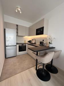 a kitchen with a table and a chair in it at Waterfront studio in Balatonszemes