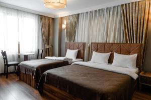 a hotel room with two beds and a table at Roza Taksim in Istanbul
