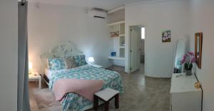 a bedroom with a bed with a blue comforter at Villa Florencia Bavaro in Punta Cana