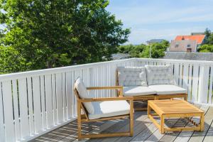 a patio with two chairs and a table on a balcony at Hotel Villa Lejet in Tisvilde