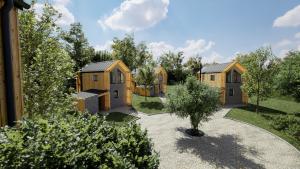 a row of wooden homes in a garden at Resort Na Peci in Nová Pec