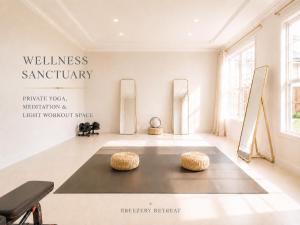a gallery with two ottoman stools in a room at Breezery Retreat - 8 Min to Airport - Indoor Pool Sauna Wellness Billiards Sports Court in Richmond