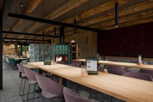 a restaurant with tables and chairs and a fireplace at Resort Na Peci in Nová Pec +19 photos