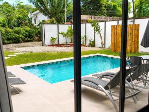 a swimming pool with two lounge chairs and a pool at Villa Isora in Talamanca