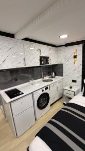 a kitchen with a sink and a washing machine in a room at TAKSİM LARİSSA RESİDENCE in Istanbul +162 photos