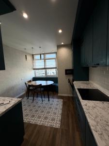a kitchen with a table and a dining room at 56 Жемчужина in Odesa +4 photos