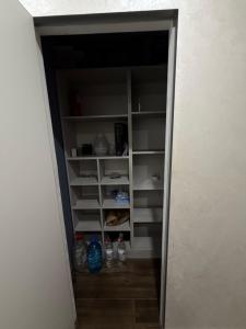 a walk in closet with bottles of water in it at 56 Жемчужина in Odesa