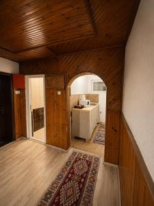 a room with an archway with a kitchen in the background at Pure Sleep in Prizren