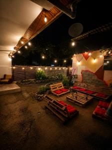 a patio at night with several beds and lights at Pure Sleep in Prizren
