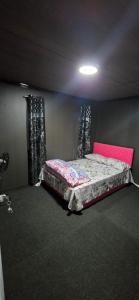a bedroom with a bed in a room with curtains at Haven Apartments- Nadi in Nadi