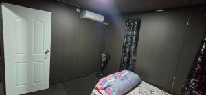 a room with a bedroom with a bed and a air conditioner at Haven Apartments- Nadi in Nadi