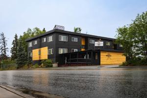 a black and yellow building on the side of a street at Highliner Suites Hotel in Anchorage