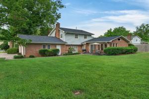 a house with a yard with green grass at Muirs Chapel Retreat in Greensboro