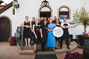a group of people posing for a picture on a statue at RESTAURACE A PENZION U DOUBKŮ in Břeclav