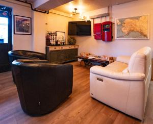 a living room with two chairs and a couch at Highliner Suites Hotel in Anchorage