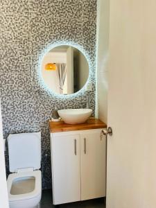 a bathroom with a sink and a mirror at Carmela, Colonia Estrella in Carmelo