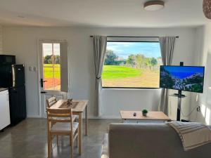 a living room with a couch and a table at Carmela, Colonia Estrella in Carmelo +17 photos